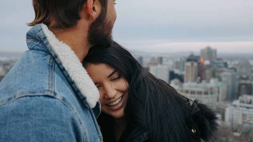 A girl hugging a boy 